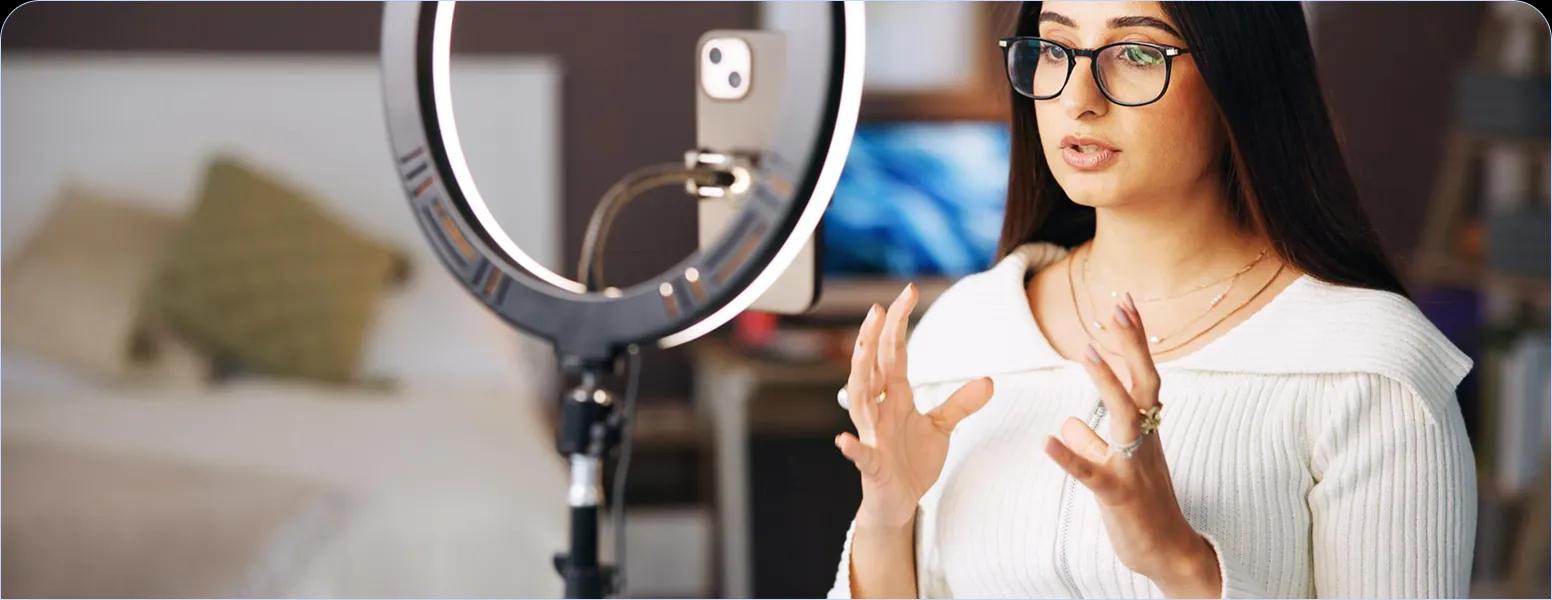 A creator filming with a ring light
